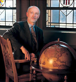 History Professor Richard Johnson, a native of England, has a world of ideas about why the American Revolution is still being felt in the U.S. today. Photo by Kathy Sauber. Globe courtesy 1-World Globes, Seattle.