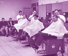 Male students and faculty at the HUB barber shop
