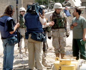 A TV crew interviews Maj. Gen. Chiarelli prior to the Iraqi elections. On election day, ABC's Peter Jennings followed Chiarelli as he toured the city. Photo courtesy of the Dept. of Defense.