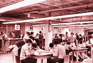 Before the days of computer registration and the World Wide Web, students in this 1970s-era photograph sit down to fill out volumes of paperwork to register for classes.  File photo.