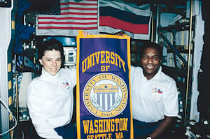 UW alumni Bonnie Dunbar, '71, '75; and Michael Anderson, '81, show their Husky spirit on a 1998 space shuttle mission. Photo courtesy NASA.