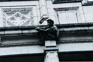 A Savery Hall gargoyle celebrating the crew program at the UW is covered with slimy green algae. Photo by Kathy Sauber.